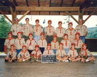21 Scouts and Adults dressed in Class A uniforms.  The sign in front of them says 