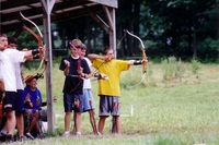 There are three scouts holding a stretched out bow, ready to shoot.