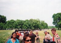A crowd of people walking towards the Vietnam Veterans Memorial Wall.