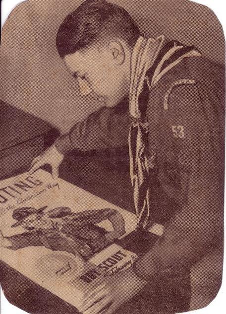 Boy looking at a Scouting magazine.