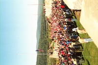 All of the scouts and adults from the campout standing around the flag pole on the fort.  The American flag is half way up the pole.