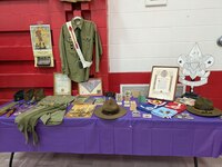 A bunch of scouting memorabilia.  There are four old class A uniforms, an old Boy's Life Magazine, old neckerchiefs, and patches.