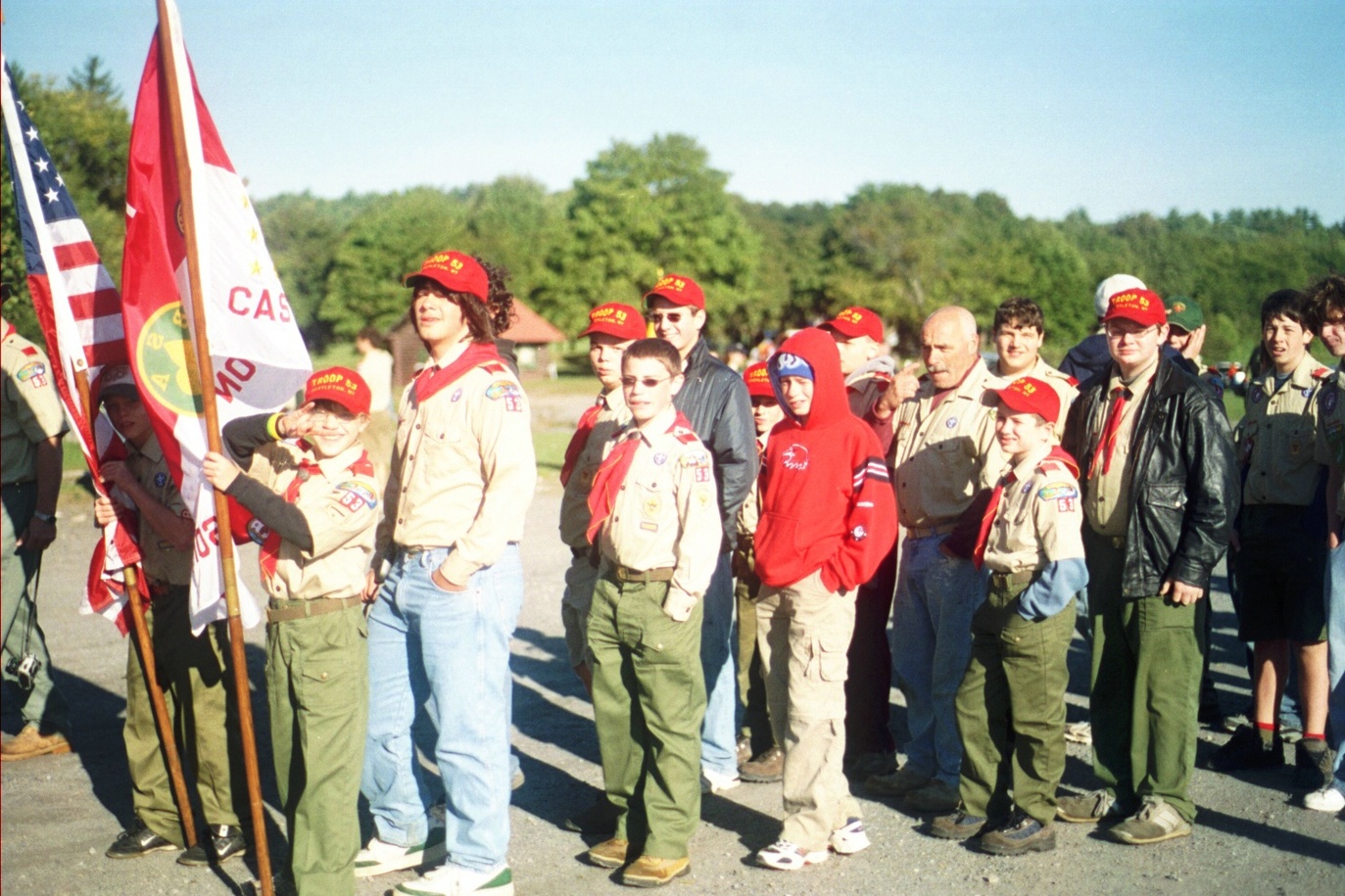 Scouts lining up behind the American flag and the troop flag.