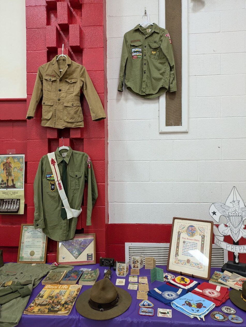 A bunch of scouting memorabilia.  There are four old class A uniforms, an old Boy's Life Magazine, old neckerchiefs, and patches.