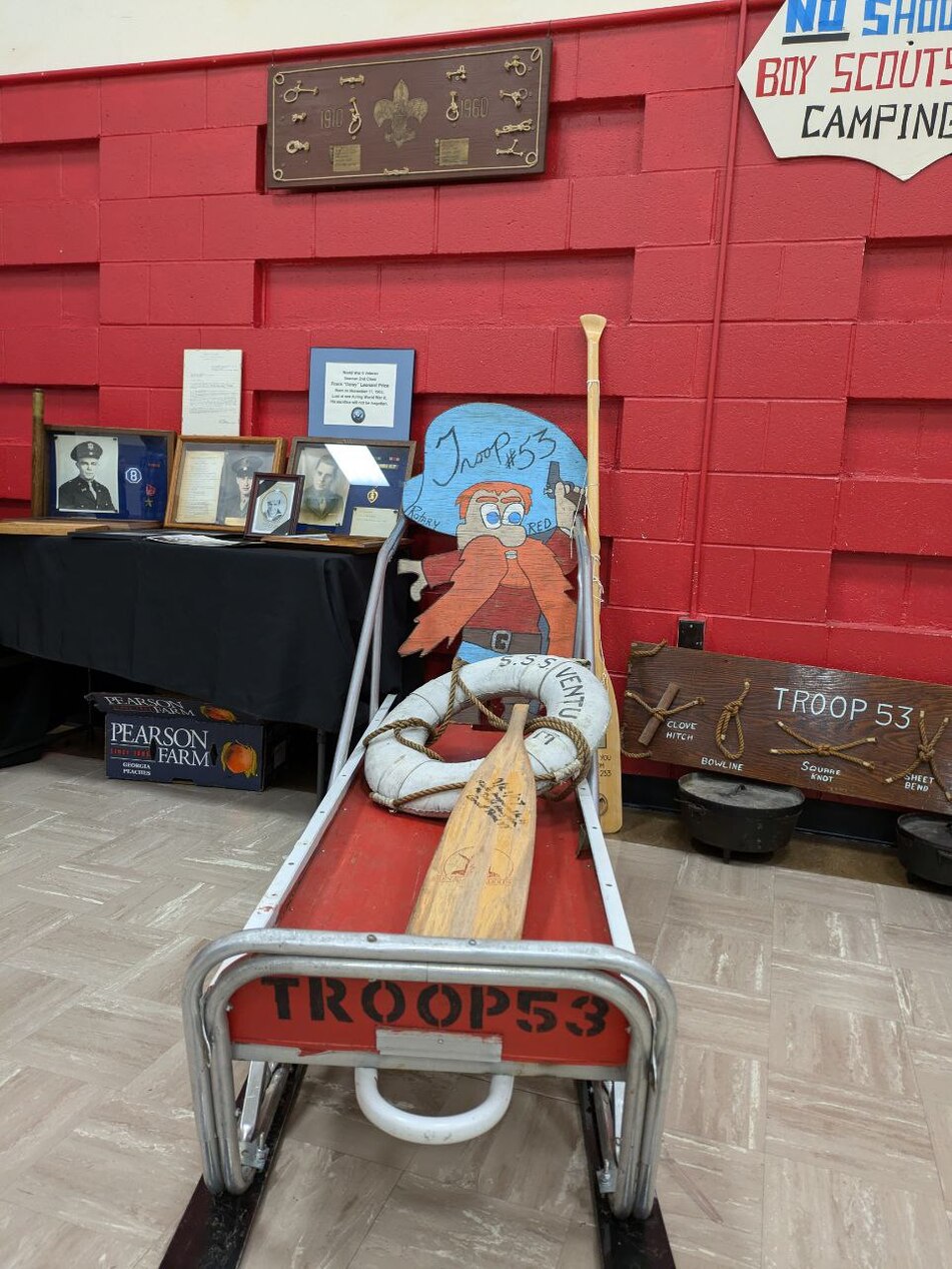 The Troop 53 sleigh, which a life raft on it.  There are also pictures of knots surrounding it.