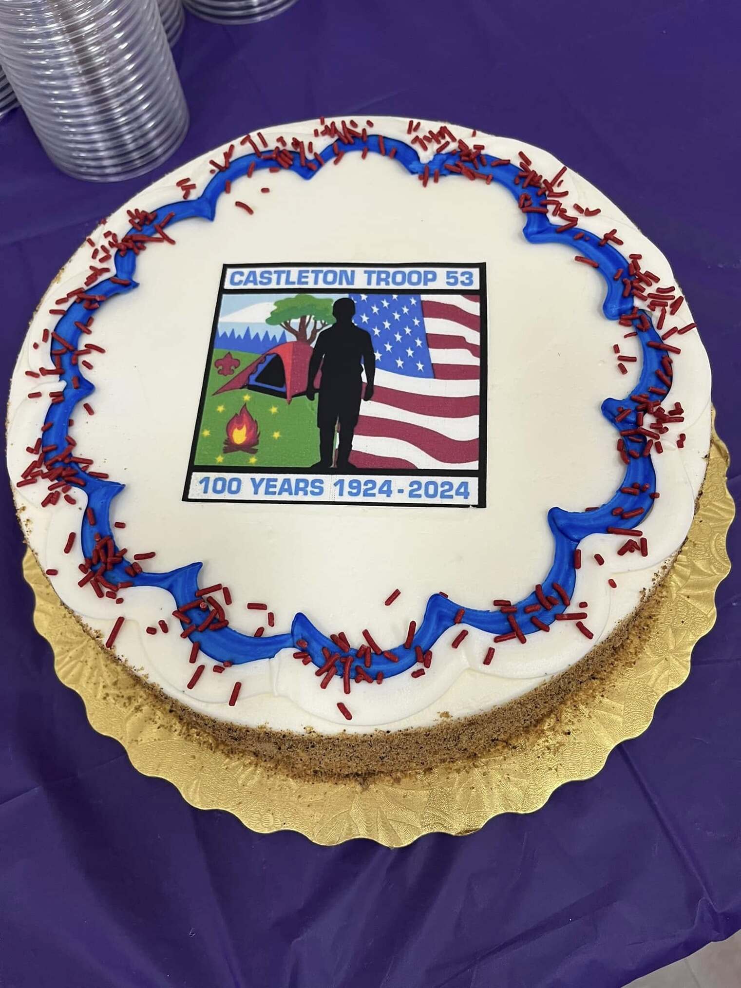 A cake that has the centennial patch on it.