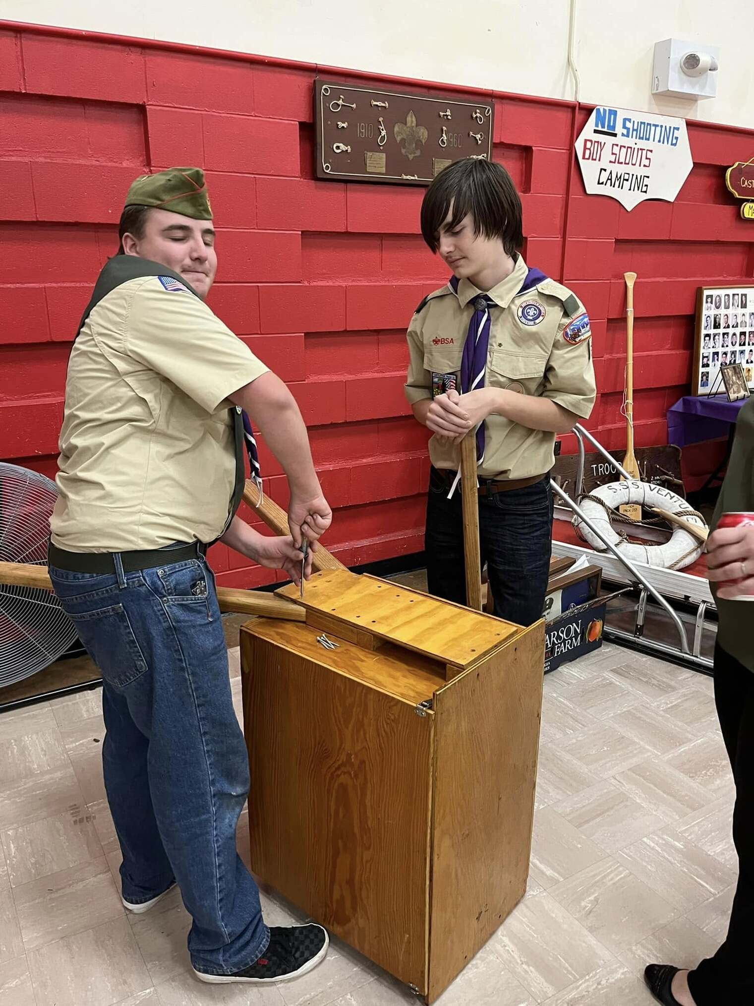 Two scouts taking apart a chuck box.