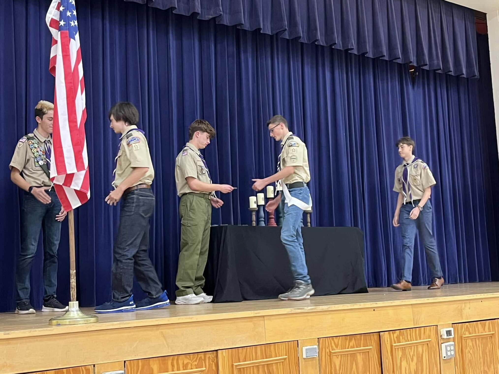 A scout giving an award to another scout.