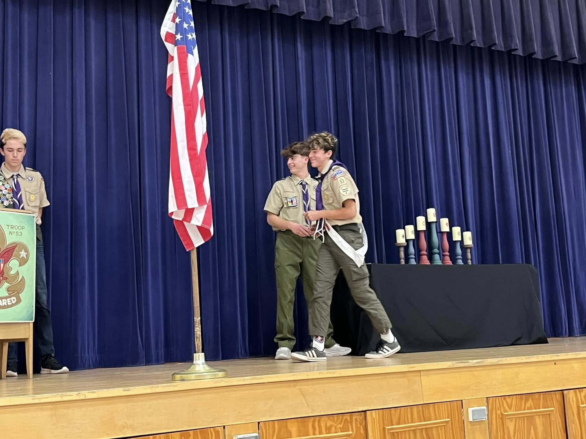 A scout giving an award to another scout.