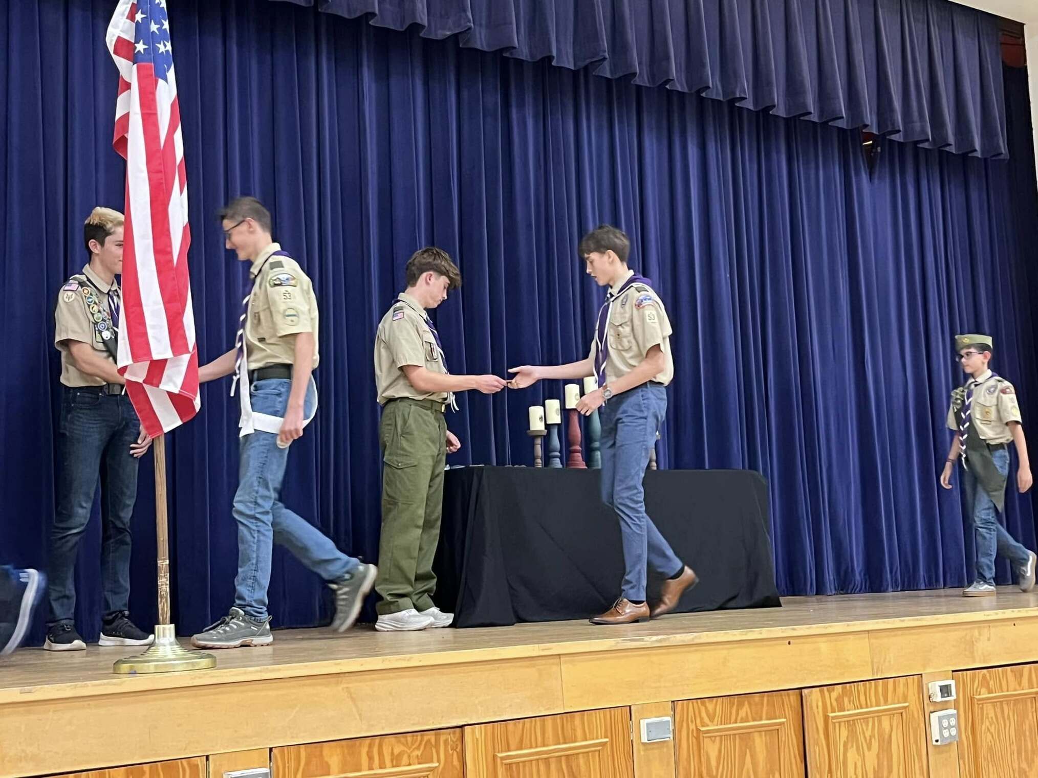 A scout giving an award to another scout.