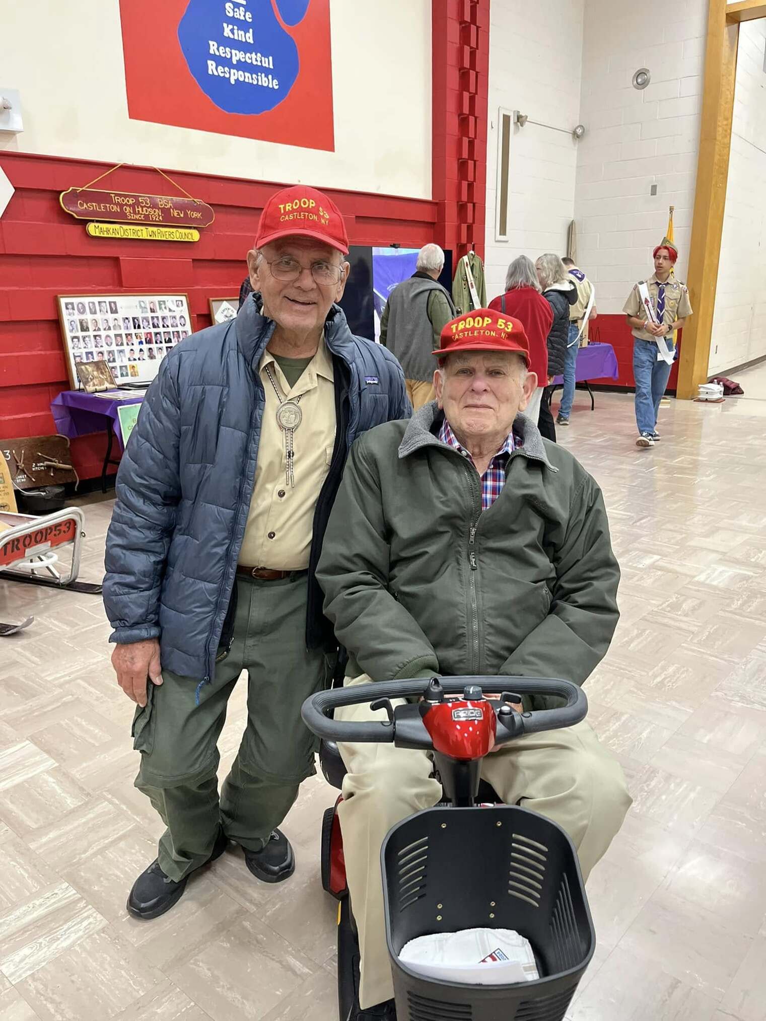 Two people wearing Troop 53 hats smiling for the camera.